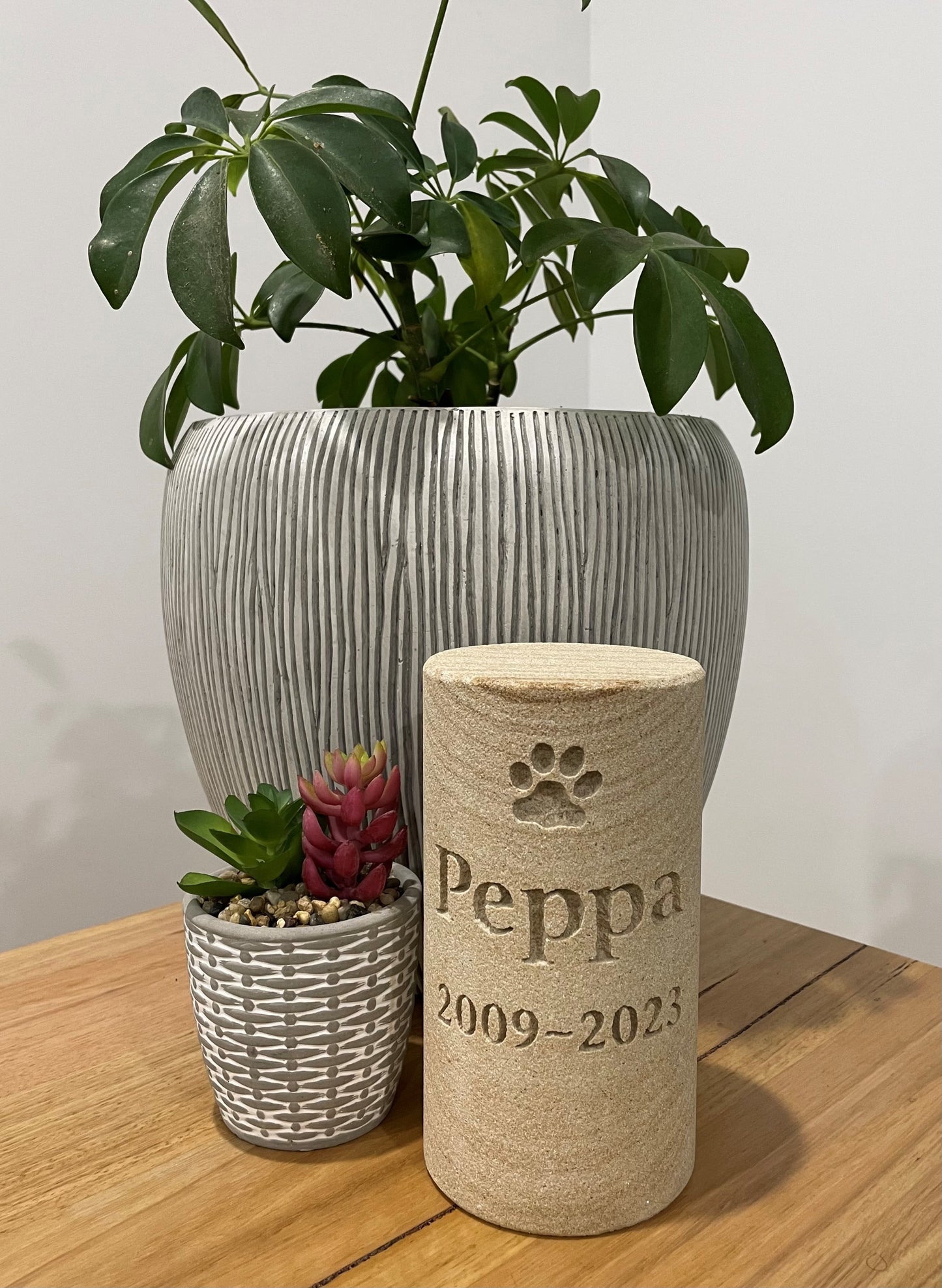 Sandstone Cycler Pet urn with memorial inscription engraved with paw print