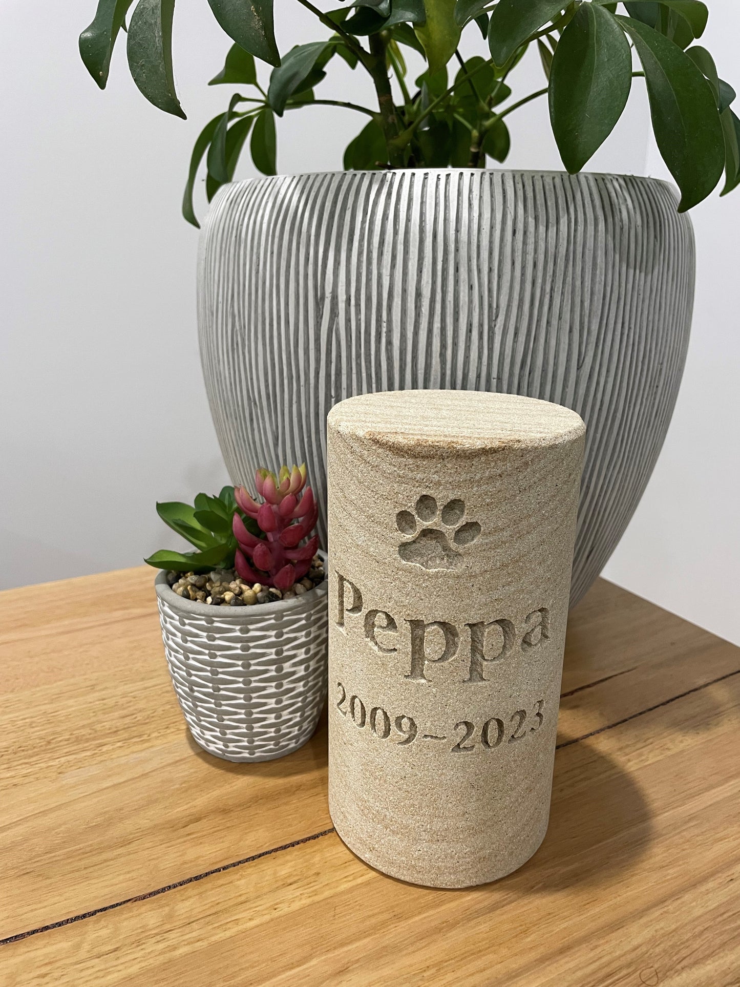 engraved sandstone cylinder pet
urn with memorial incription for a pet