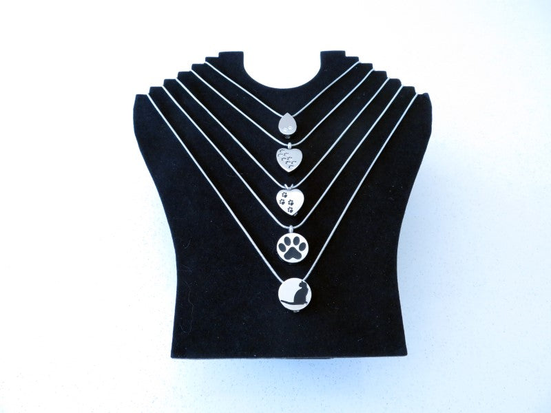 display with various pet cremation jewellery necklaces on it